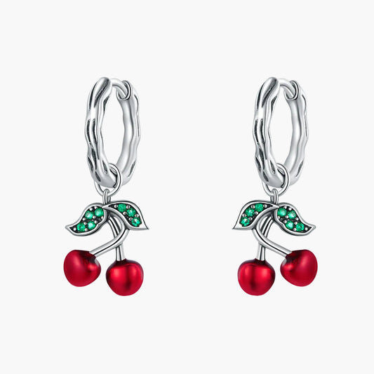 Cherry-themed earrings with red and green stones on a white background