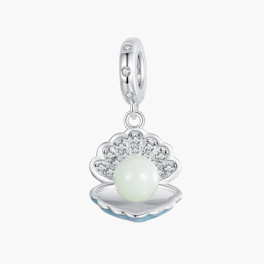 Silver charm with a pearl inside a shell on a white background